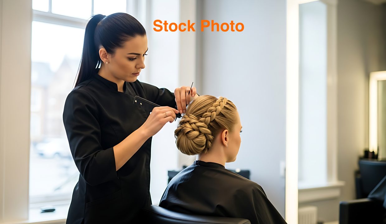 Professional Hair Stylist Styling Blonde Woman Hair in Modern Salon