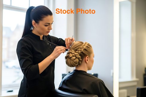 Professional Hair Stylist Styling Blonde Woman Hair in Modern Salon