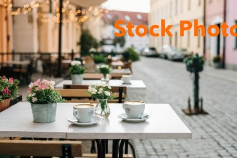 5. vecteezy_cozy-outdoor-cafe-with-flowers-and-cobblestone-street_73752526