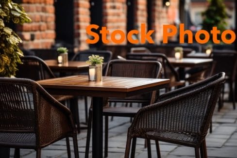 vecteezy_ai-generated-outdoor-restaurant-sitting-chairs-with-tables_35786704