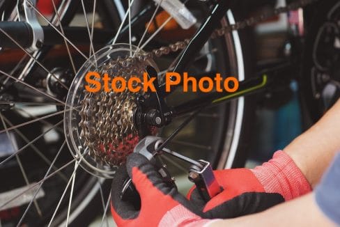 03. vecteezy_bike-mechanic-repairs-folding-bicycle-in-workshop-adjust_7135637 copy