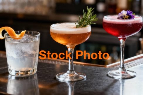 1. vecteezy_three-distinct-handcrafted-cocktails-rest-attractively-on-a_73573094